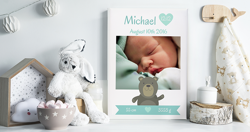 A Photo Canvas with the birth details of a child, placed on a shelf next to teddy bears and decorations
