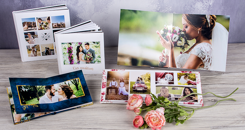 Five wedding layflat albums in various sizes, 3 of them are open flat
