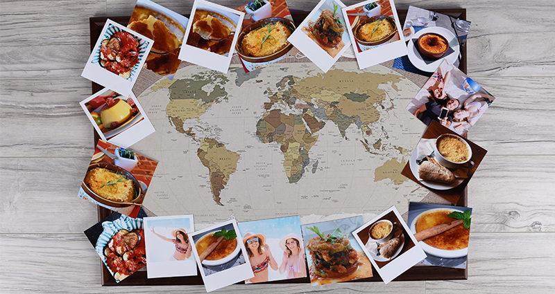 Insta photos and retro prints of food lying around the world map