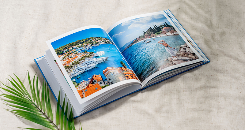 An open photo book from vacation, full of summer memories.