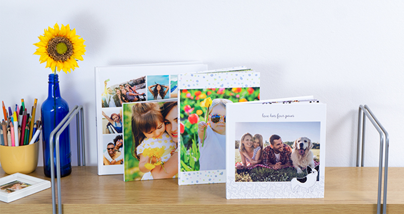 A 24x24 Photo Book placed on a shelf next to other Photo Books