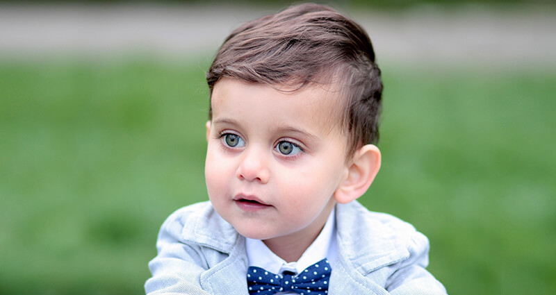 A big-eyed boy dressed with a bow-tie.