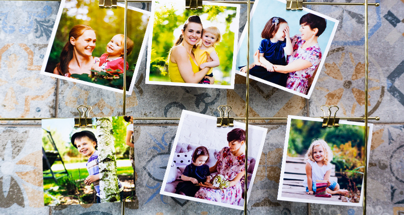 A close-up on spring insta photos hanging on a metal frame. Mosaic tiles in the background.