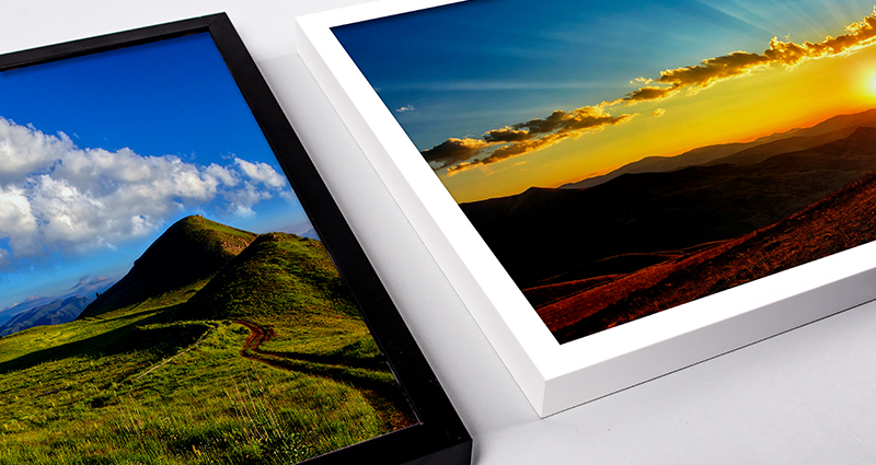 Focus on two framed landscape canvases