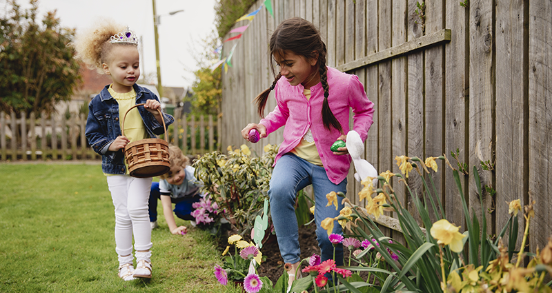 Girls looking for chocolate Easter eggs