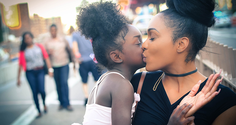 Mom kissing a baby girl