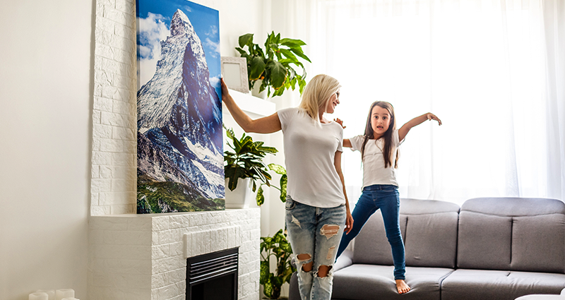 Mother and daughter presenting a holiday photo canvas 