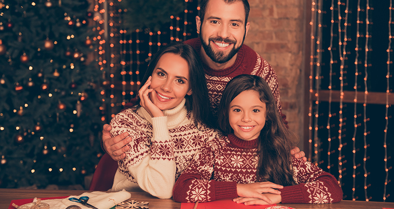 Mama, papa en een meisje tijdens een fotoshoot van de kerstvoorbereidingen