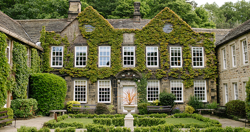 Symmetrical residence overgrown by vines