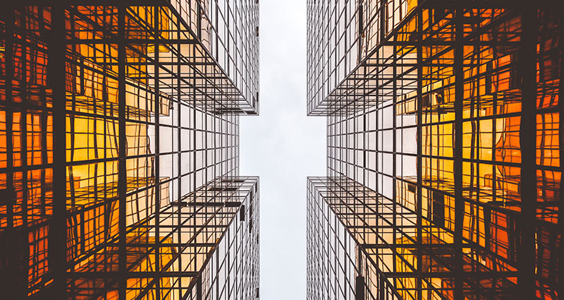 A photo of sky between two symetric buildings.