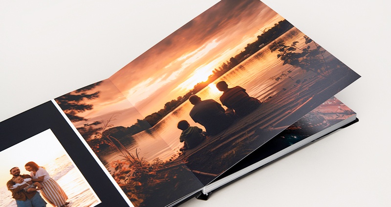 Photo book with panoramic spreads featuring a family photo against the backdrop of a sunset. 
