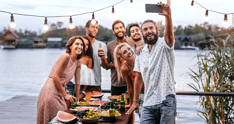 Un gruppo di amici che fa dei selfie ispirandosi ai suggerimenti e ai trucchi sulla fotografia di viaggio per principianti