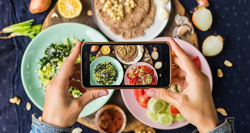 A photo of food on three differently colored plates taken with a smartphone, aerial view.