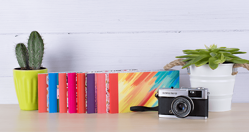 Share books with different covers on a shelf.